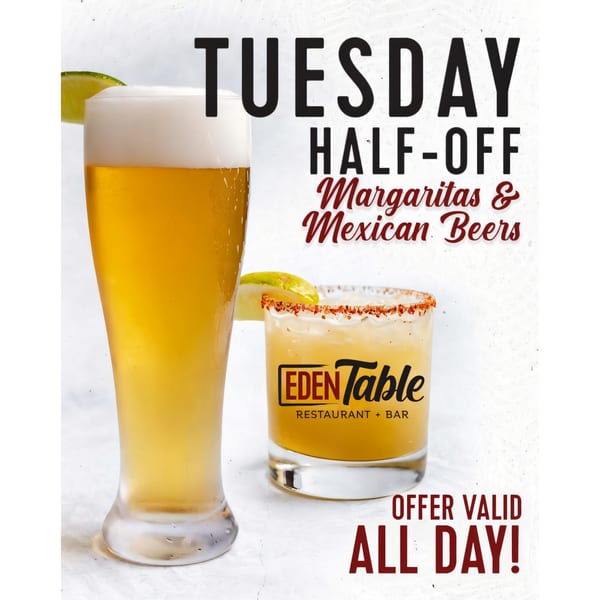 A tall glass of beer and a margarita with a chili-salt rim, advertising Eden Table's half-off Tuesday special.